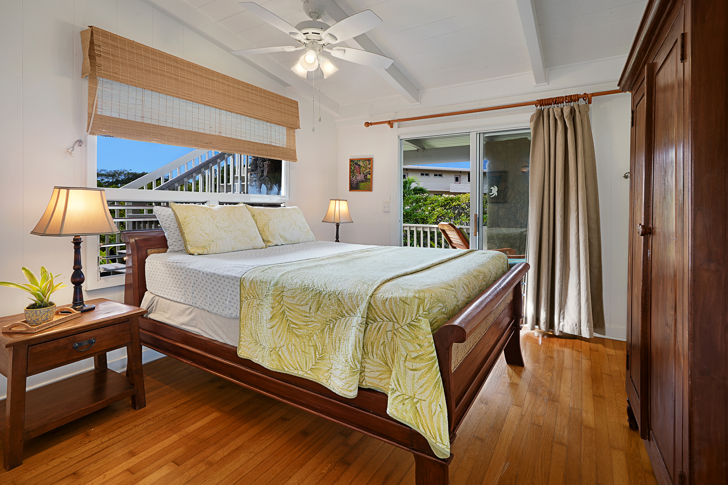 2261 Ho'ohu Road Koloa, HI 96756 - Photo 12 of 17 a bedroom with a bed a lamp on the table and a window