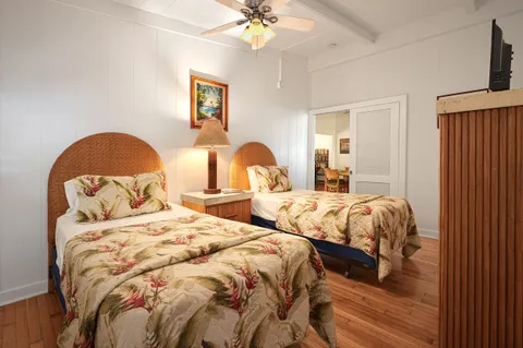 a bedroom with two beds and a chandelier