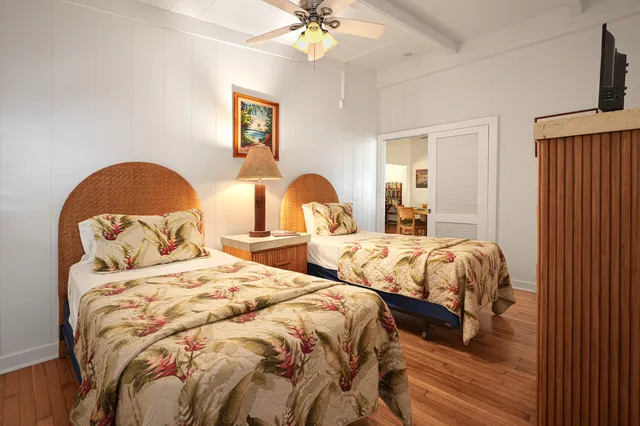 a bedroom with two beds and a chandelier