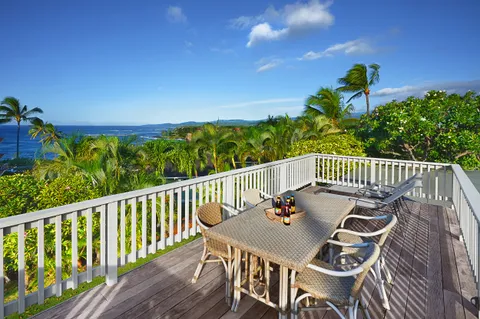 a view of a balcony with wooden floor and outdoor seating