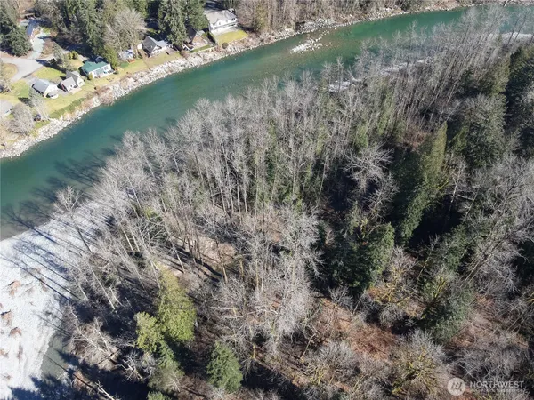 a view of a lake with beach and green space