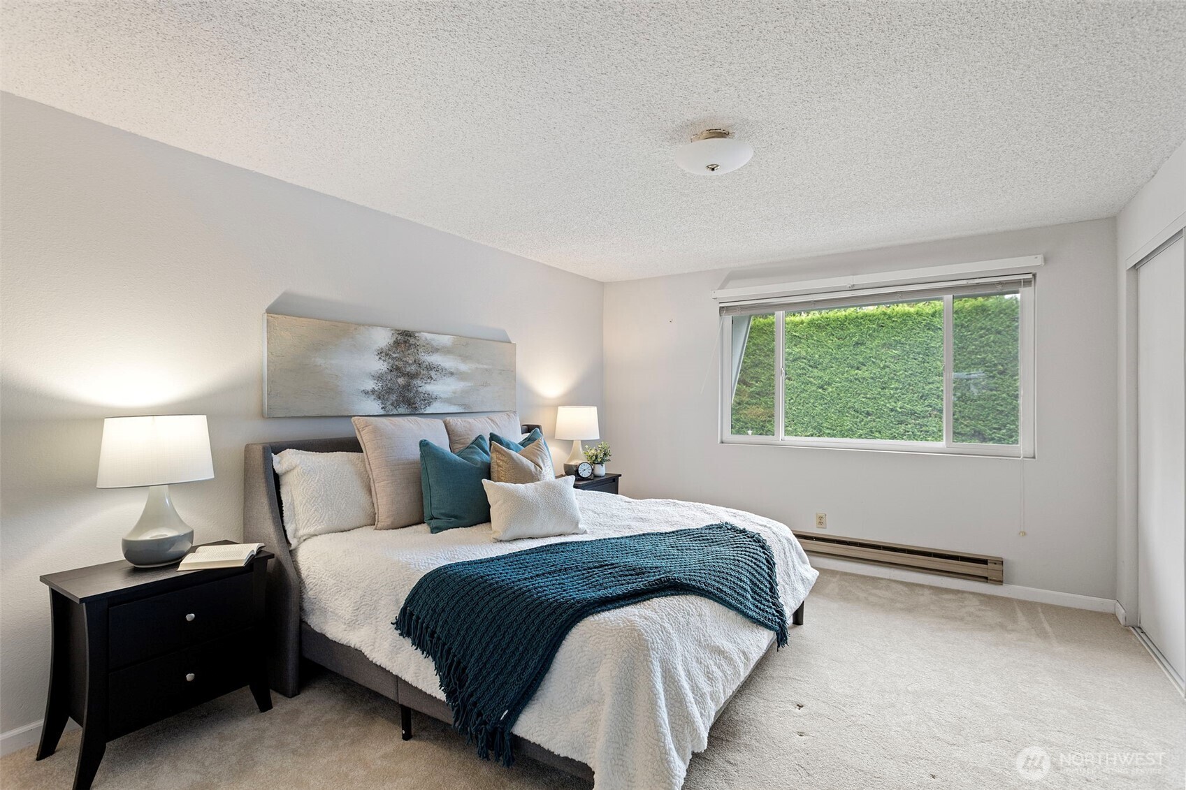 20714 76th Avenue West, Unit 11 Edmonds, WA 98026 - Photo 14 of 29 a bedroom with a bed and a lamp on dresser