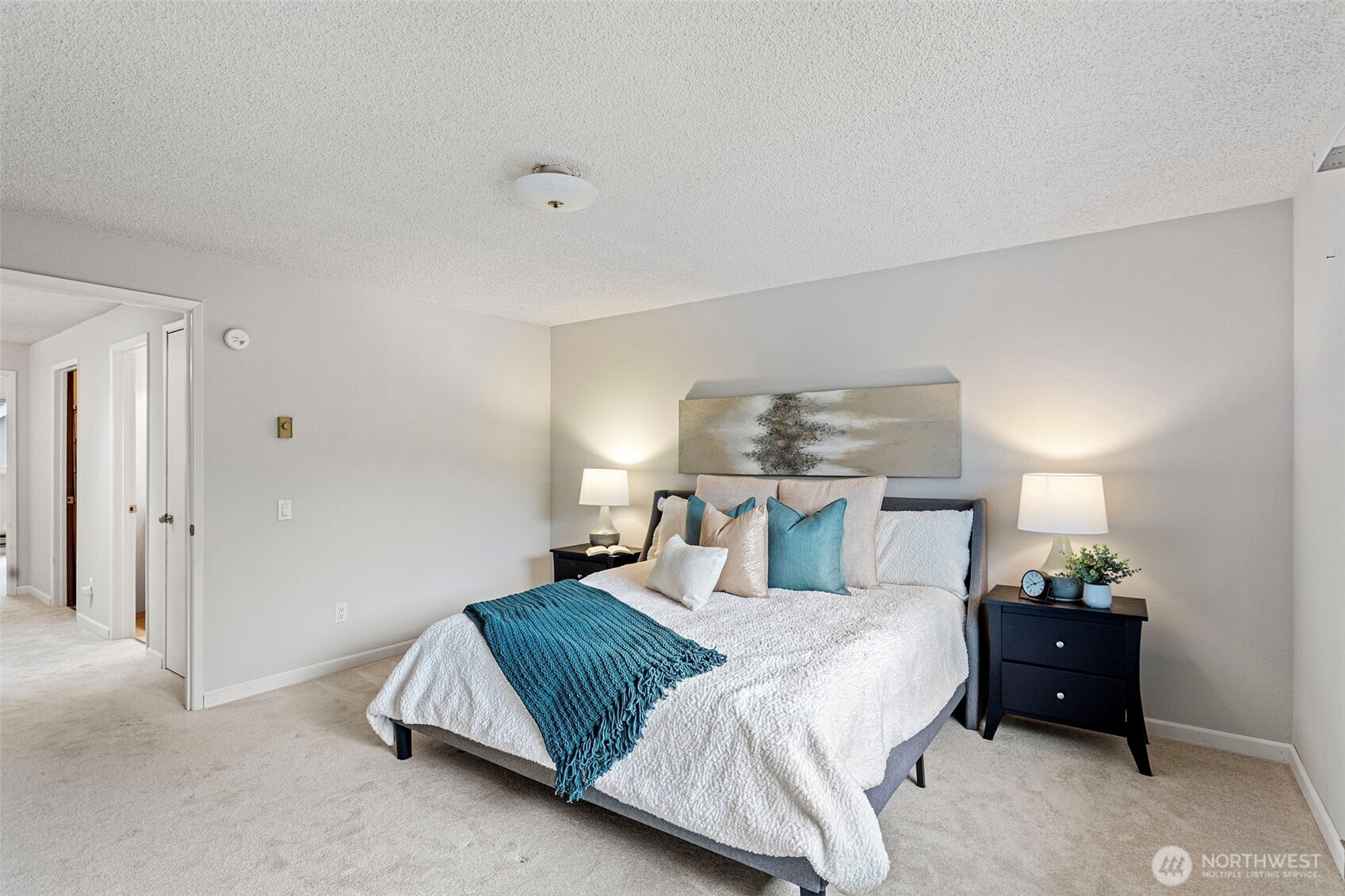 20714 76th Avenue West, Unit 11 Edmonds, WA 98026 - Photo 15 of 29 a bedroom with a bed and chandelier