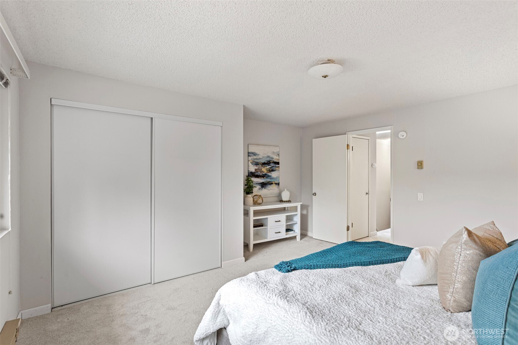 20714 76th Avenue West, Unit 11 Edmonds, WA 98026 - Photo 16 of 29 a bedroom with a bed and cabinets