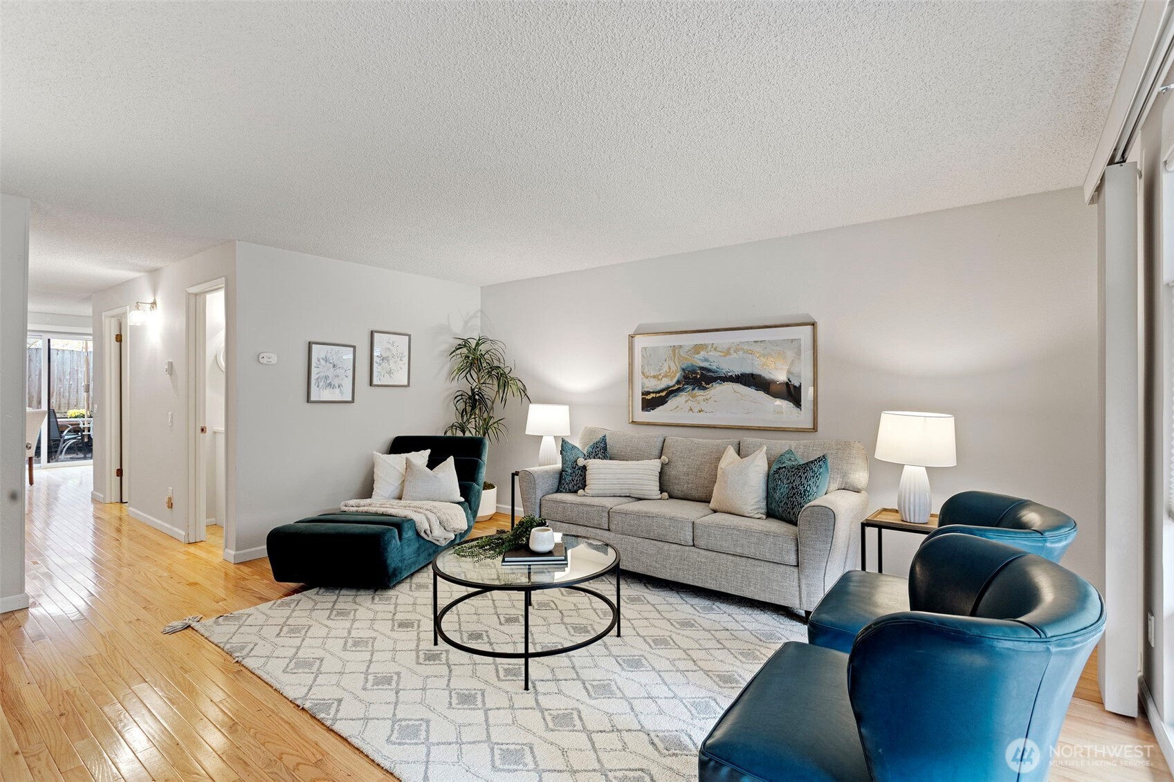 20714 76th Avenue West, Unit 11 Edmonds, WA 98026 - Photo 3 of 29 a living room with furniture and a wooden floor