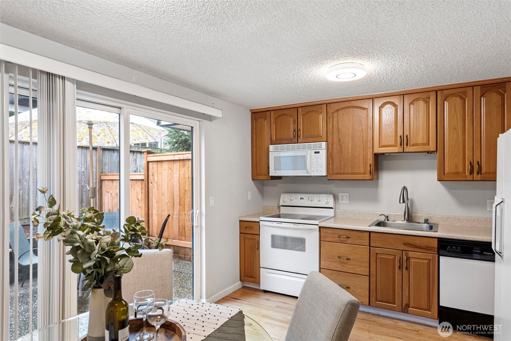 20714 76th Avenue West, Unit 11 Edmonds, WA 98026 - Photo 8 of 29 a kitchen with a refrigerator and a sink