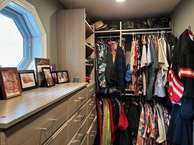 14 A Reed Street Londonderry, NH 03053 - Photo 23 of 39 a view of walk in closet with clothes