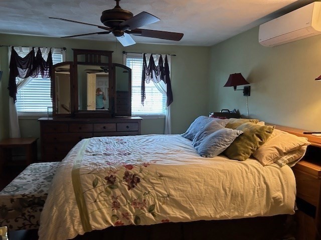 14 A Reed Street Londonderry, NH 03053 - Photo 27 of 39 a bedroom with a bed and wooden floor