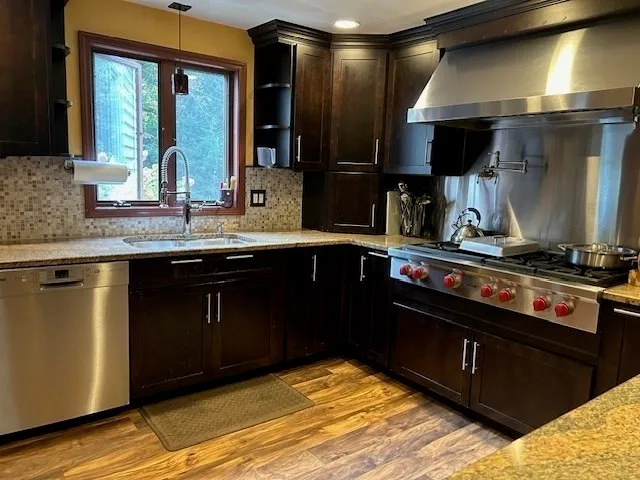 a kitchen with a sink stove and cabinets