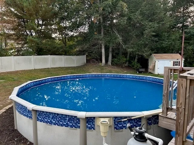 a view of a chairs and table in the back yard
