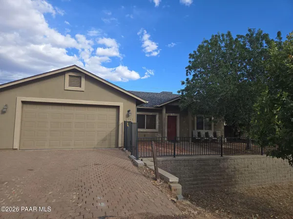 a front view of a house with garage