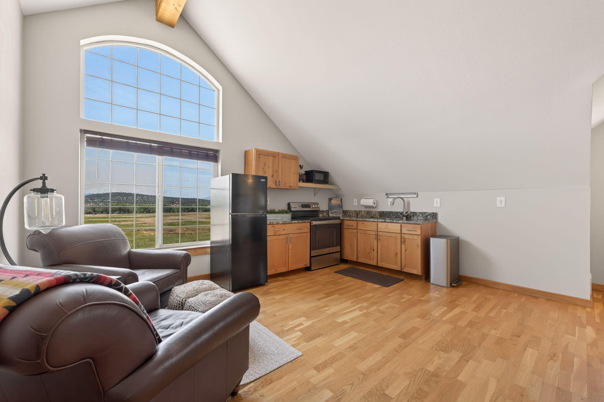 20180 Winston Loop Bend, OR 97703 - Photo 45 of 59 a living room with furniture a window and kitchen view