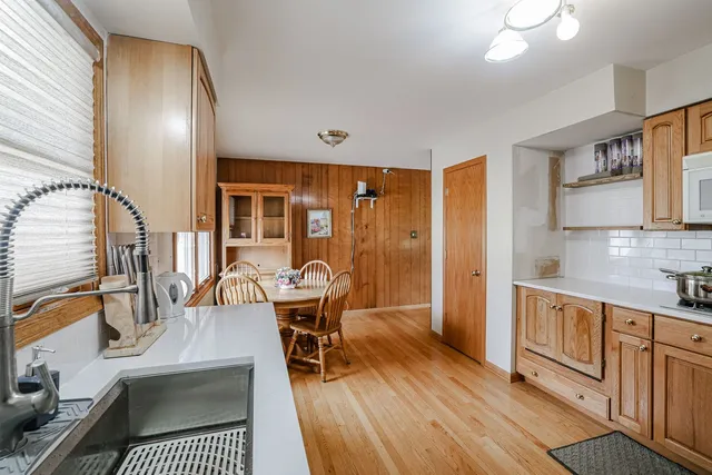 a view of a dining room with furniture a rug and wooden floor