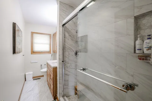 a bathroom with a shower and a toilet