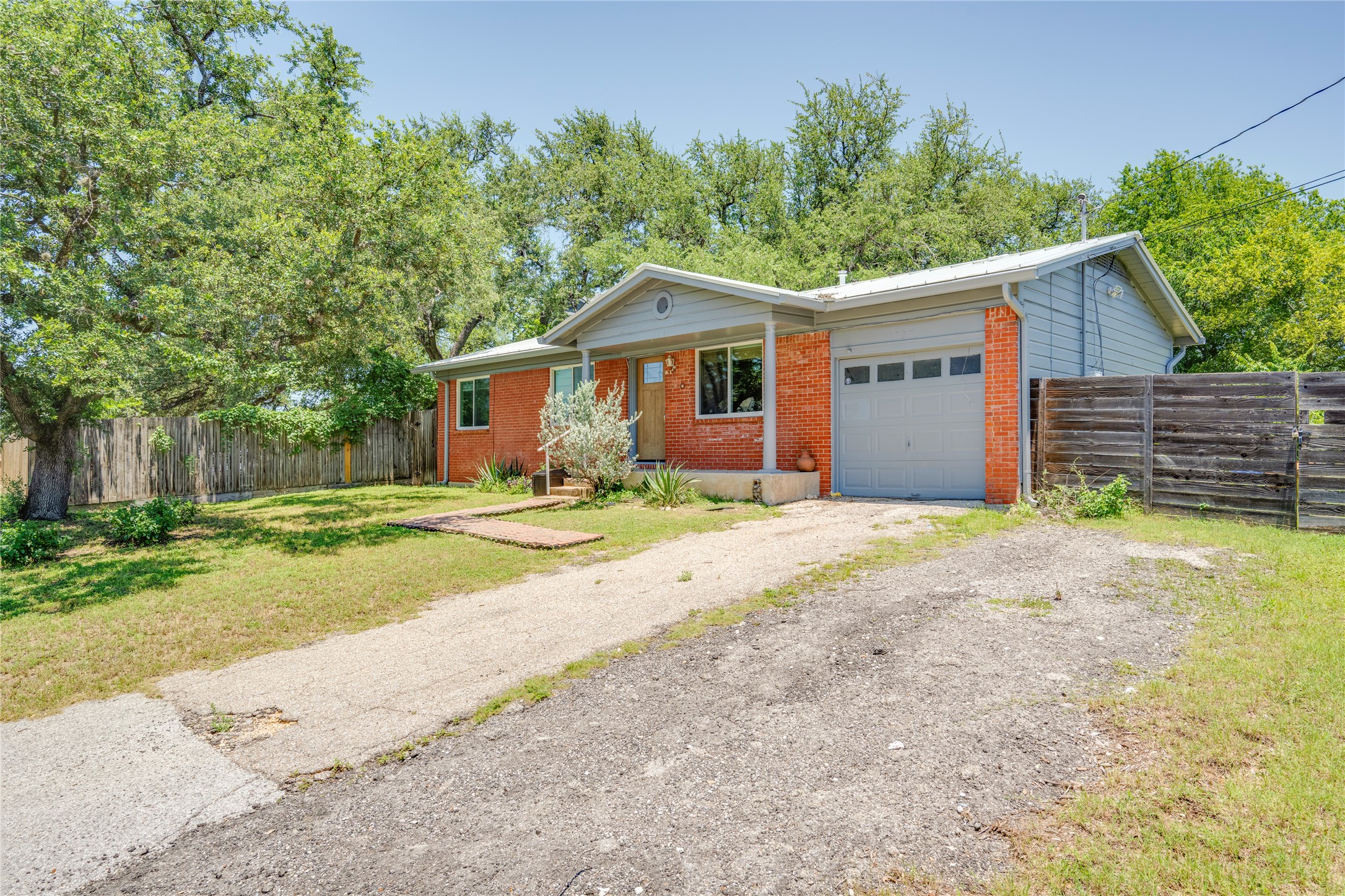 1707 Overhill Drive Austin, TX 78721 - Photo 2 of 36 A classic brick exterior with a welcoming porch and mature shade trees defines this charming residence.