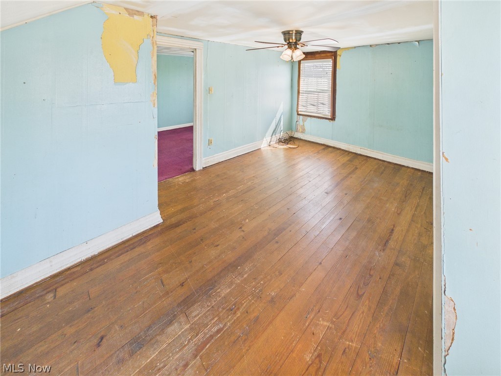 834 Lake Washington Road Washington, WV 26181 - Photo 13 of 20 Empty room with wood flooring and a ceiling fan