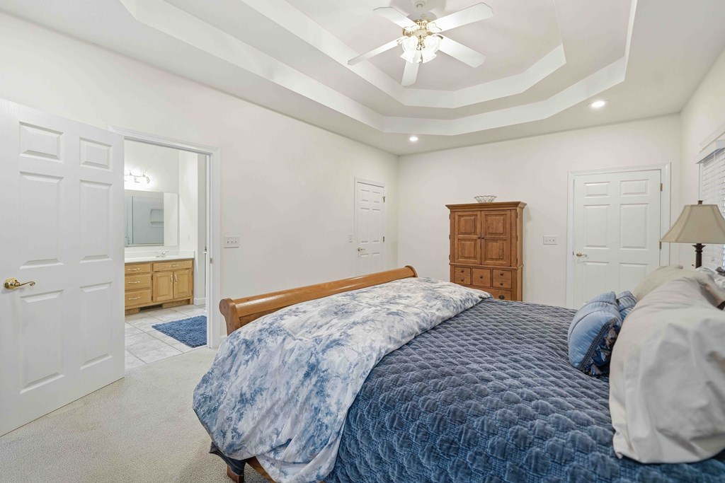 174 White Tail Ridge Road Jasper, GA 30143 - Photo 20 of 66 a bedroom with a bed and a chandelier