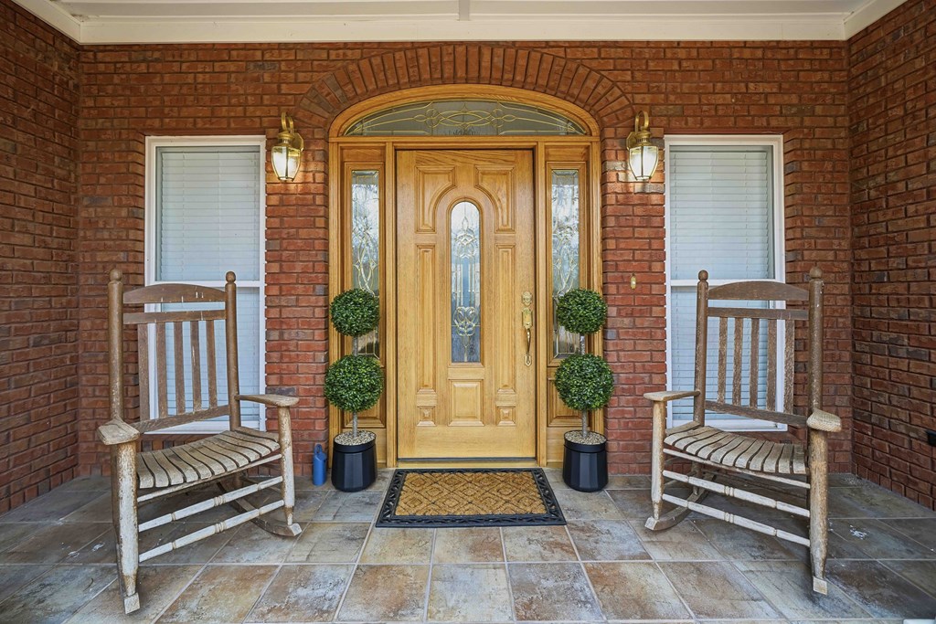 174 White Tail Ridge Road Jasper, GA 30143 - Photo 2 of 66 a front view of a house with outdoor seating and a potted plant