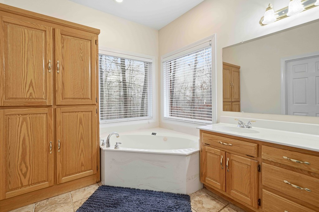174 White Tail Ridge Road Jasper, GA 30143 - Photo 23 of 66 a bath room with a sink and a bathtub