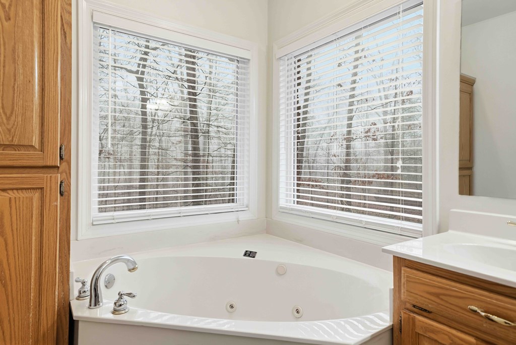 174 White Tail Ridge Road Jasper, GA 30143 - Photo 24 of 66 a white bath tub sitting next to a window