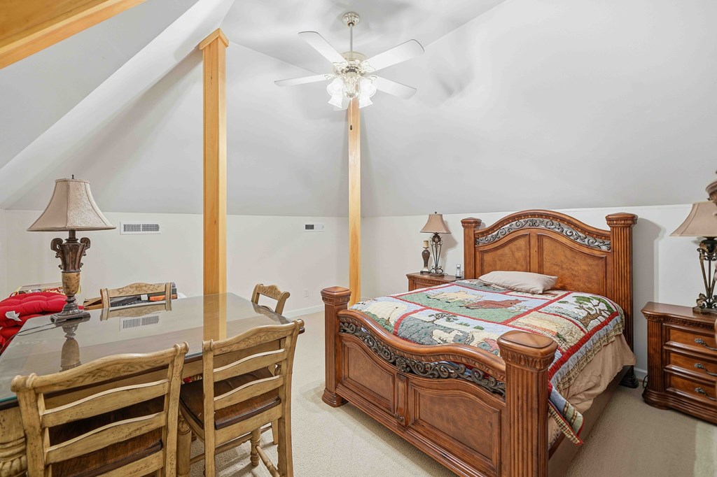 174 White Tail Ridge Road Jasper, GA 30143 - Photo 31 of 66 a bedroom with a bed and a chandelier