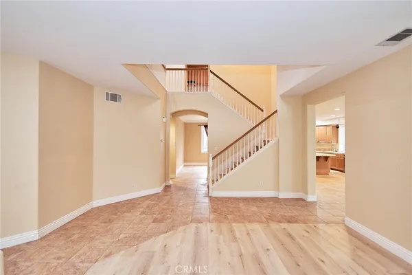 a large kitchen with kitchen island a sink a counter top space stainless steel appliances and cabinets