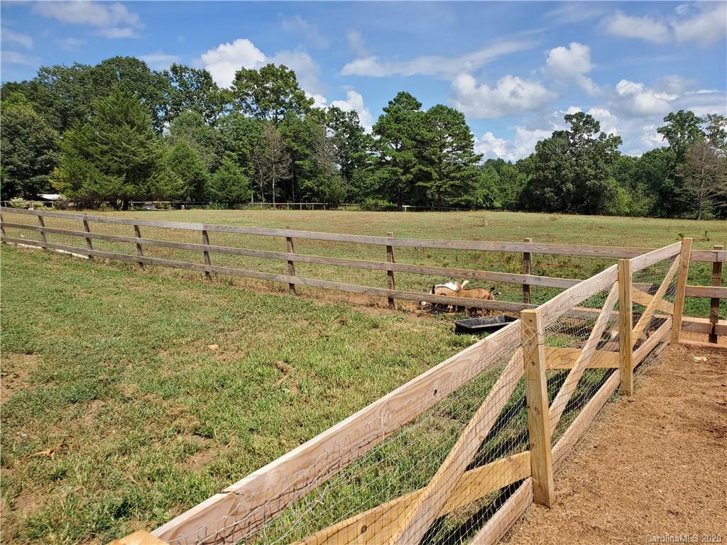 2415 Ruben Road Monroe, NC 28112 - Photo 18 of 42 a view of a field with wooden fence
