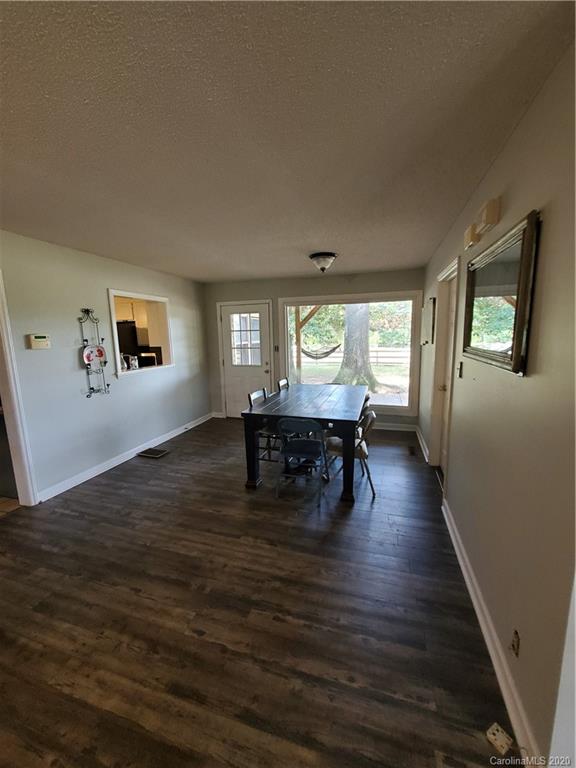 2415 Ruben Road Monroe, NC 28112 - Photo 30 of 42 a living room with fireplace and wooden floor