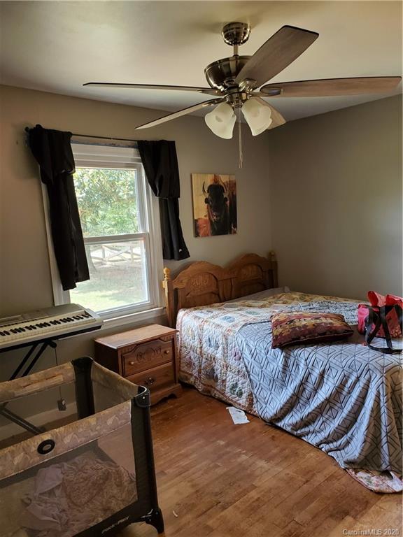 2415 Ruben Road Monroe, NC 28112 - Photo 33 of 42 a bedroom with a bed and a chandelier