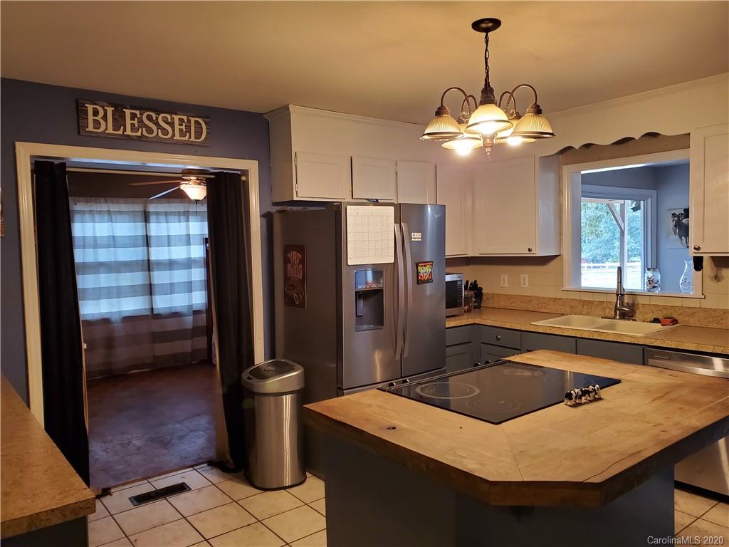 2415 Ruben Road Monroe, NC 28112 - Photo 38 of 42 a kitchen with a sink a counter space cabinets and stainless steel appliances