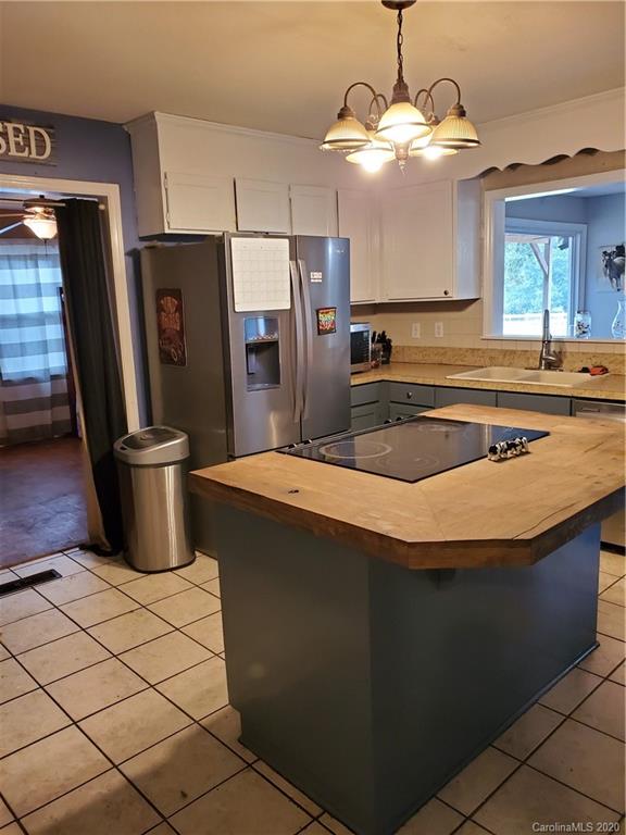 2415 Ruben Road Monroe, NC 28112 - Photo 39 of 42 a kitchen with stainless steel appliances granite countertop a sink a stove and a refrigerator