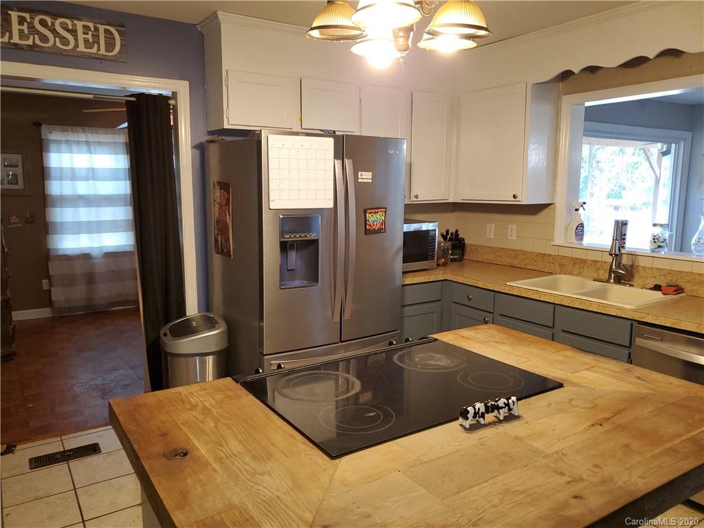 2415 Ruben Road Monroe, NC 28112 - Photo 40 of 42 a kitchen with a sink refrigerator and cabinets