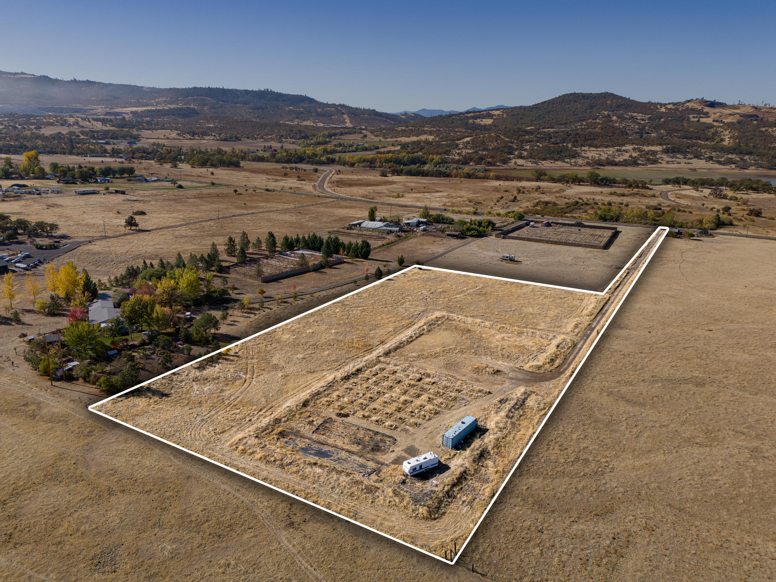 an aerial view of residential houses with outdoor space