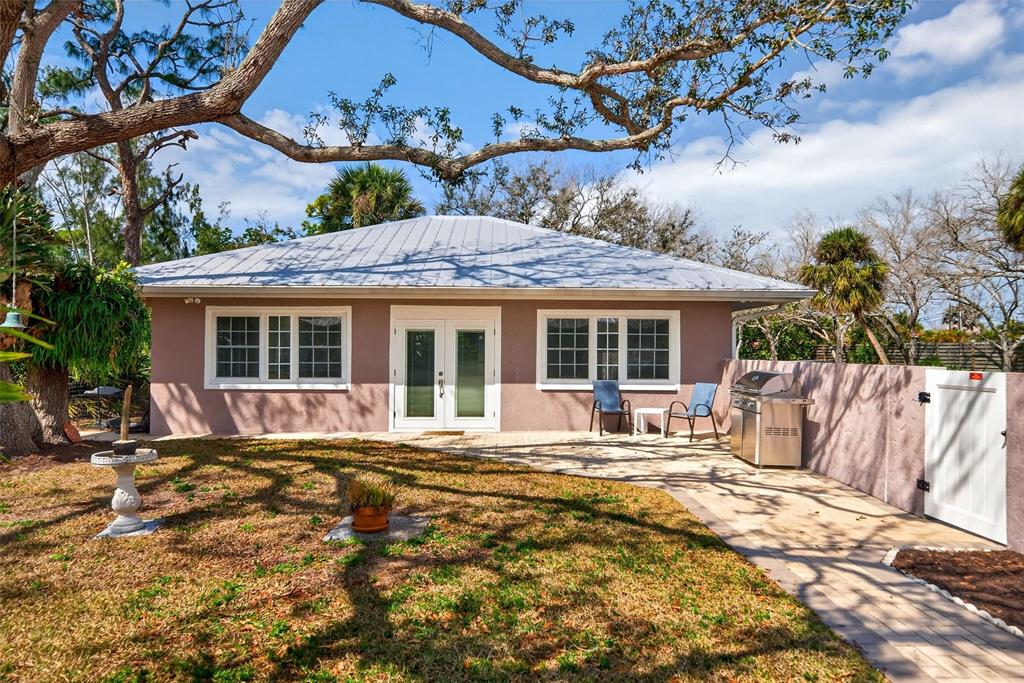 7108 Midnight Pass Road Sarasota, FL 34242 - Photo 44 of 83 a front view of a house with a yard outdoor seating and barbeque oven