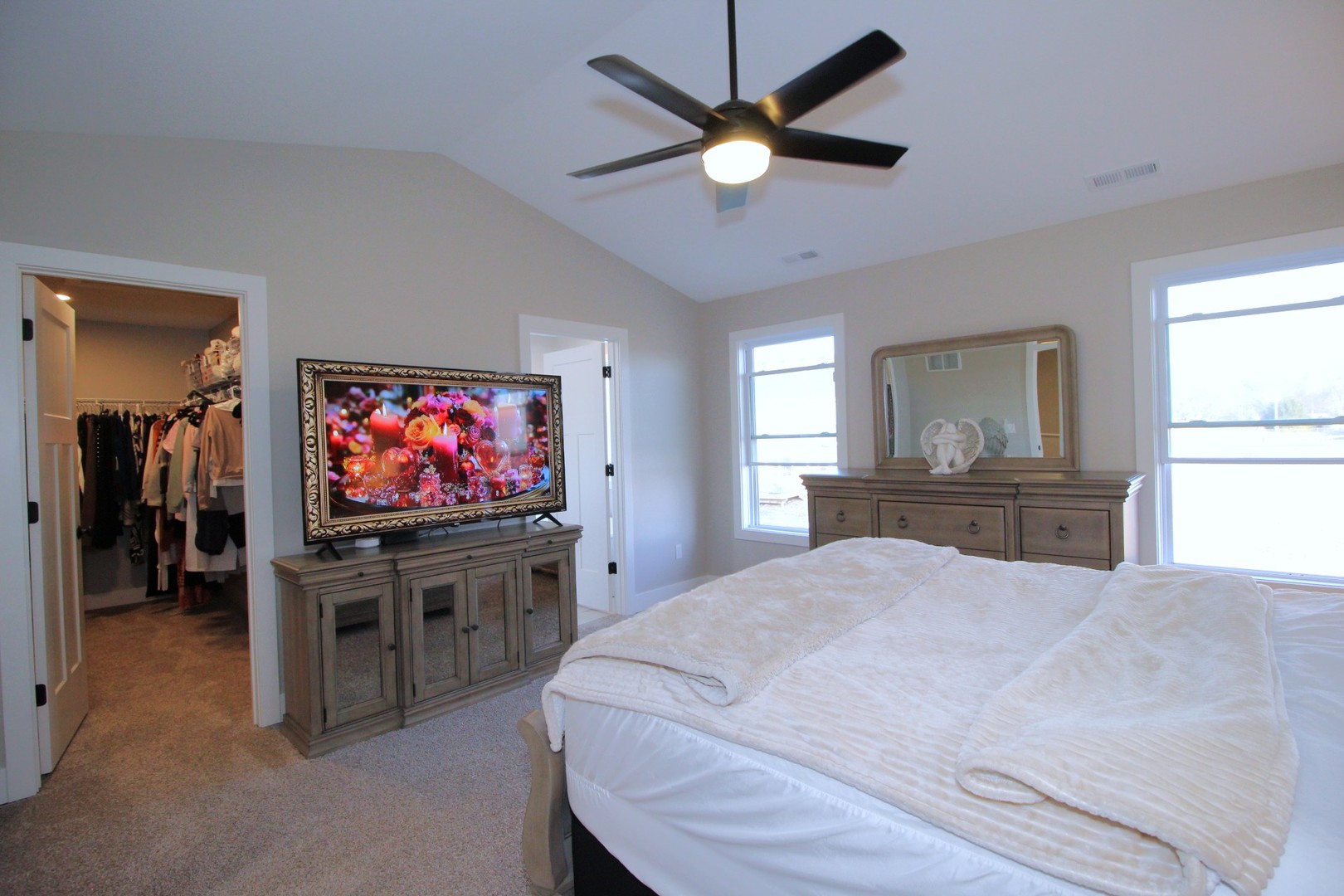 425 Jenny Lane, Unit B Heyworth, IL 61745 - Photo 14 of 25 a bedroom with a bed and a flat screen tv