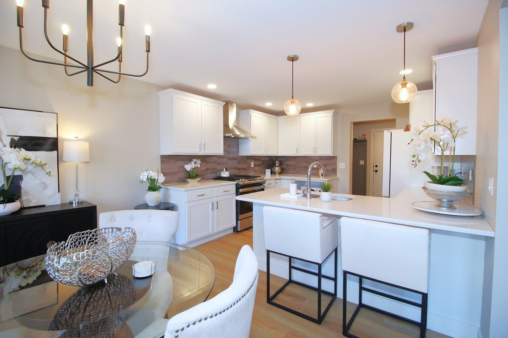 425 Jenny Lane, Unit B Heyworth, IL 61745 - Photo 4 of 25 a kitchen with stainless steel appliances kitchen island granite countertop a sink a refrigerator and chairs