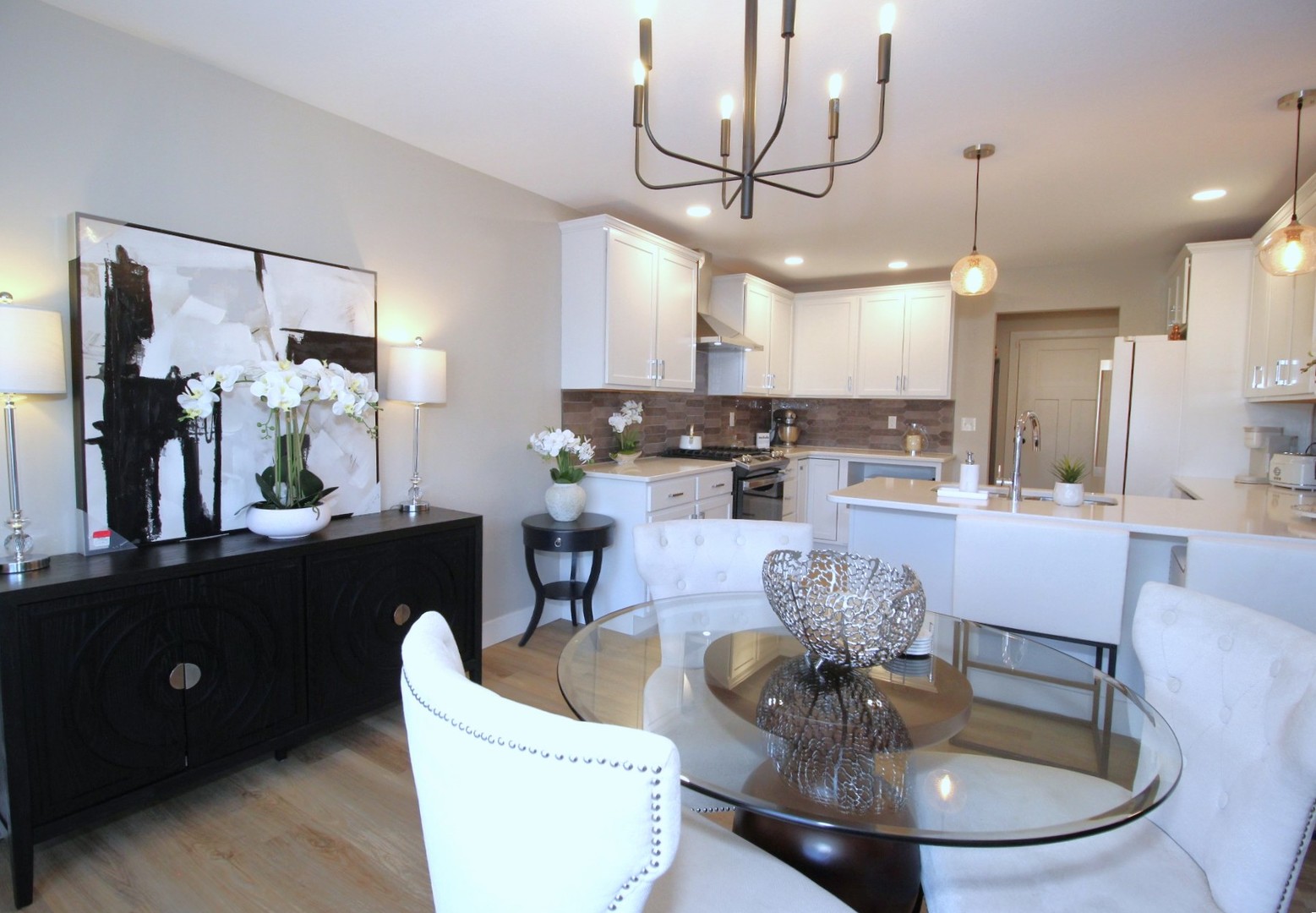 425 Jenny Lane, Unit B Heyworth, IL 61745 - Photo 6 of 25 a dining room with furniture a chandelier and kitchen view