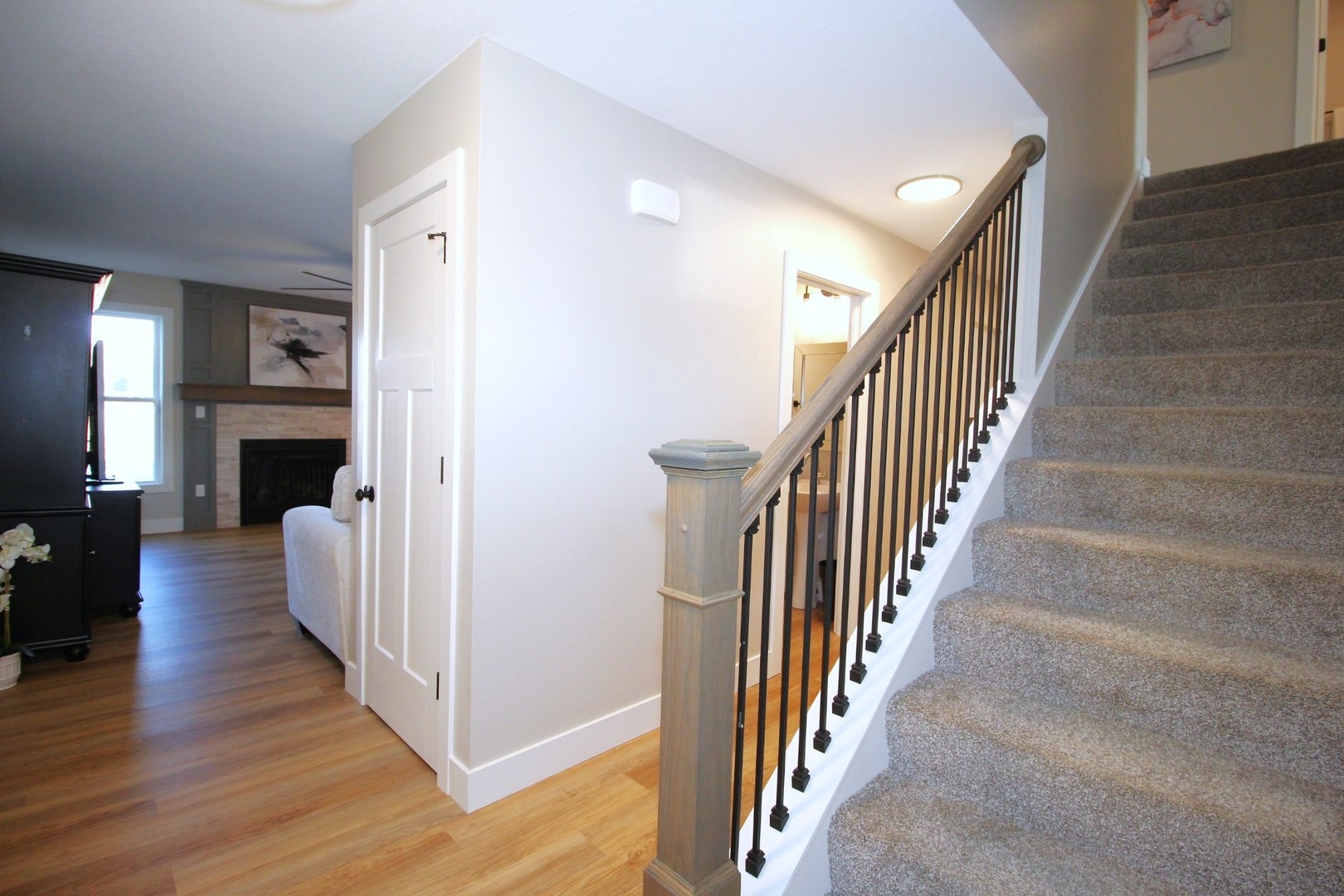 425 Jenny Lane, Unit B Heyworth, IL 61745 - Photo 9 of 25 a view of a hallway with wooden floor and staircase