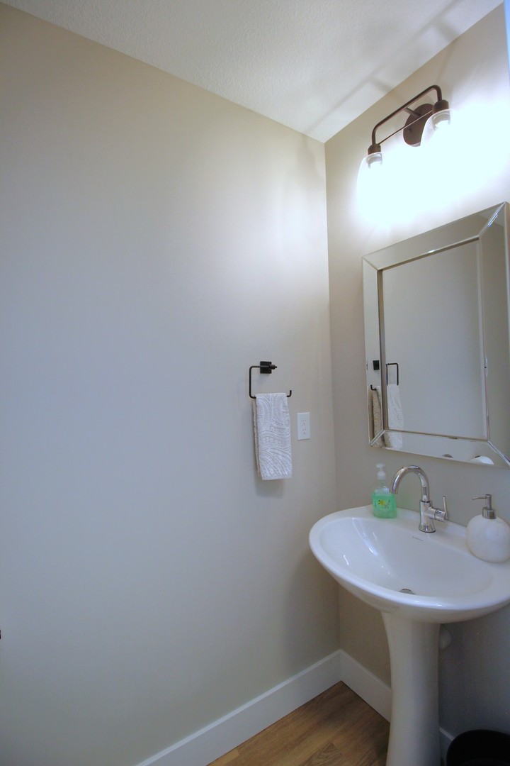 425 Jenny Lane, Unit B Heyworth, IL 61745 - Photo 10 of 25 a bathroom with a sink and a mirror