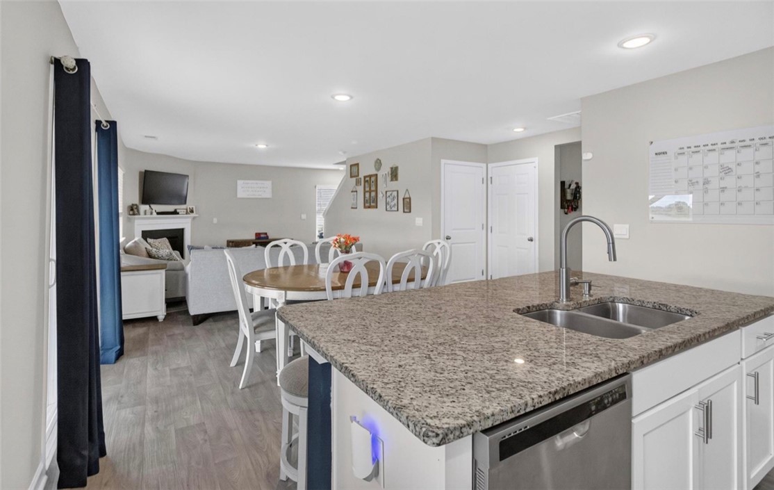 213 Millhone Way Pendleton, SC 29670 - Photo 6 of 25 An inviting open-concept layout features a well-appointed kitchen island flowing into the dining and living spaces.