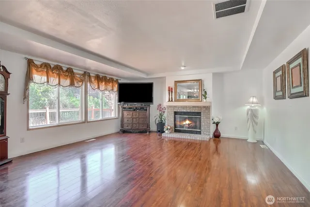 a view of a livingroom with a fireplace a fireplace and wooden floor
