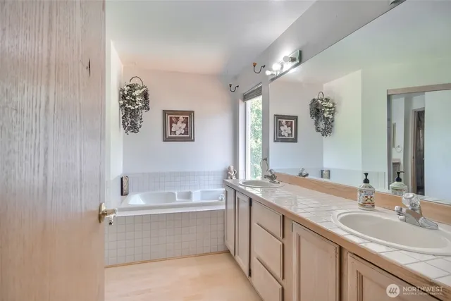 a bathroom with a granite countertop sink mirror and double