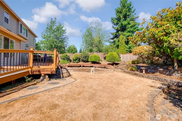 a roof deck with table and chairs under an umbrella