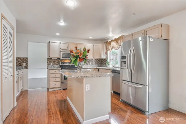 a kitchen with counter top space and stainless steel appliances