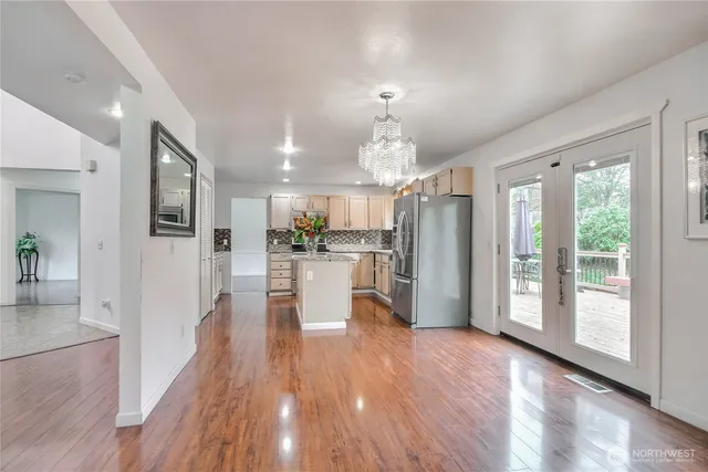 a view of a living room and kitchen with furniture wooden floor