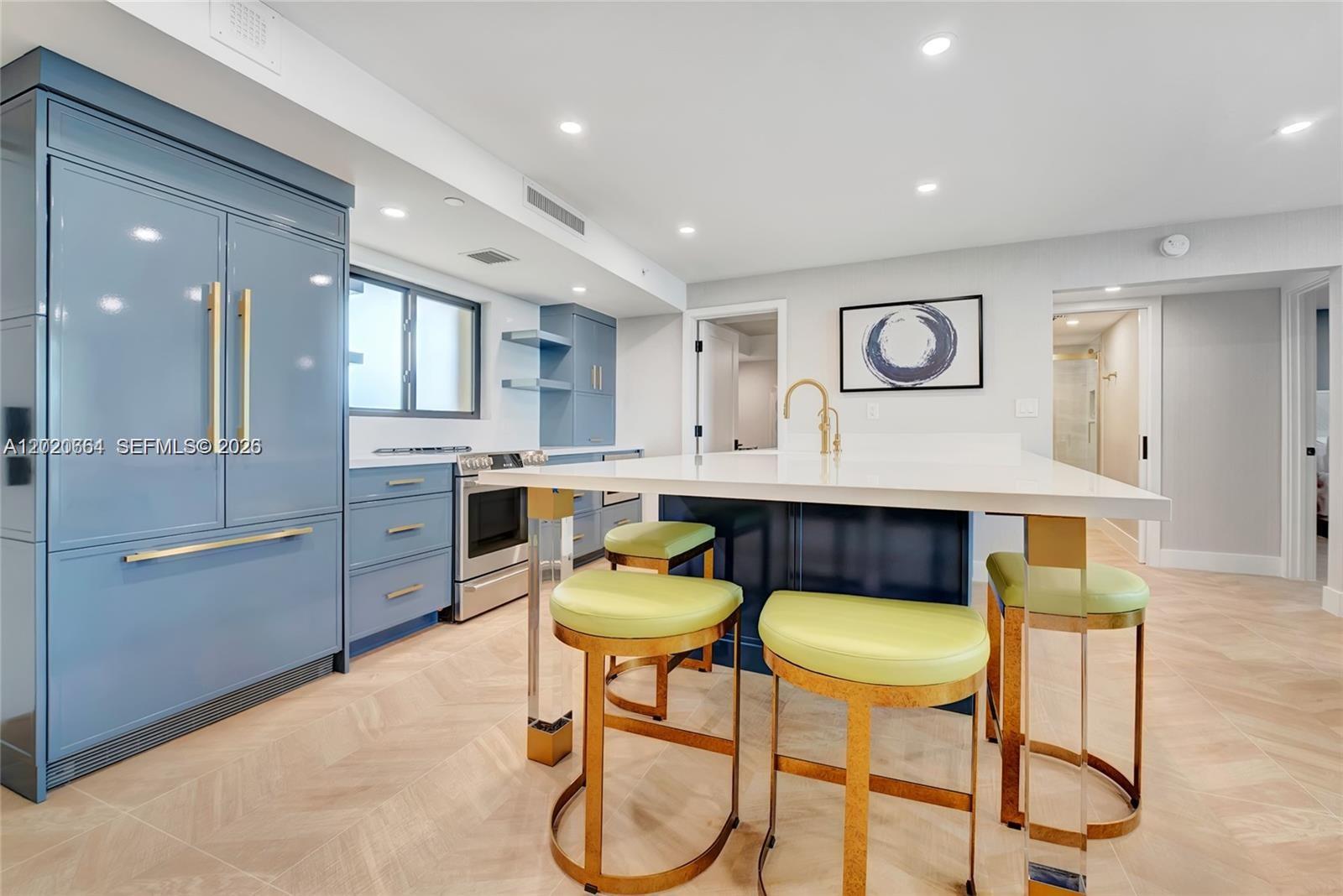 300 Ocean Trail Way, Unit 702 Jupiter, FL 33477 - Photo 1 of 31 a kitchen with a table chairs refrigerator and microwave