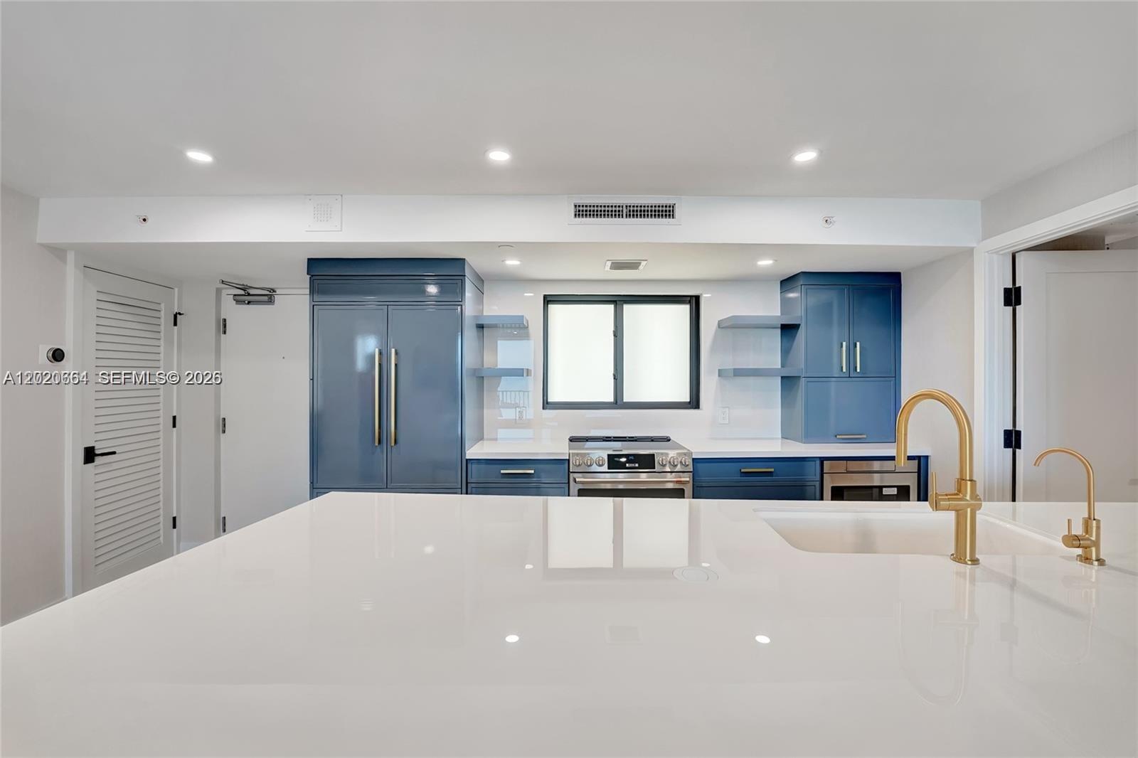300 Ocean Trail Way, Unit 702 Jupiter, FL 33477 - Photo 7 of 31 a kitchen with stainless steel appliances a sink a stove a refrigerator cabinets and a dining table
