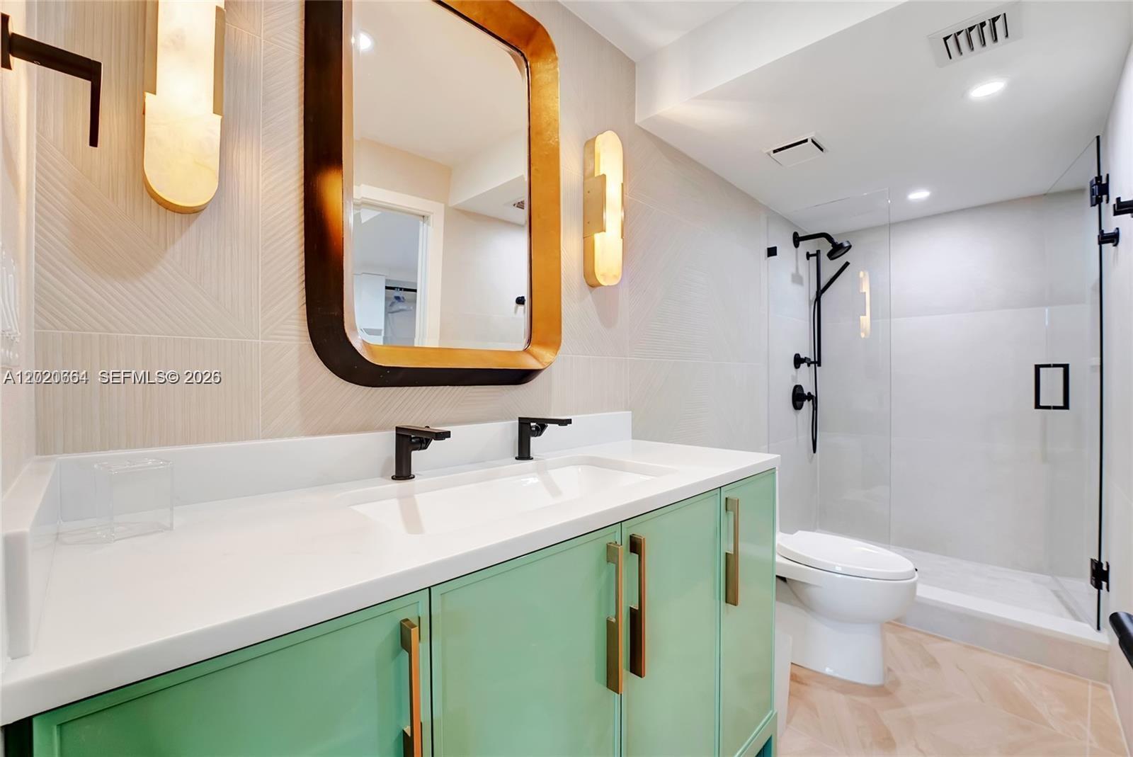 300 Ocean Trail Way, Unit 702 Jupiter, FL 33477 - Photo 10 of 31 a bathroom with a sink a toilet and a mirror