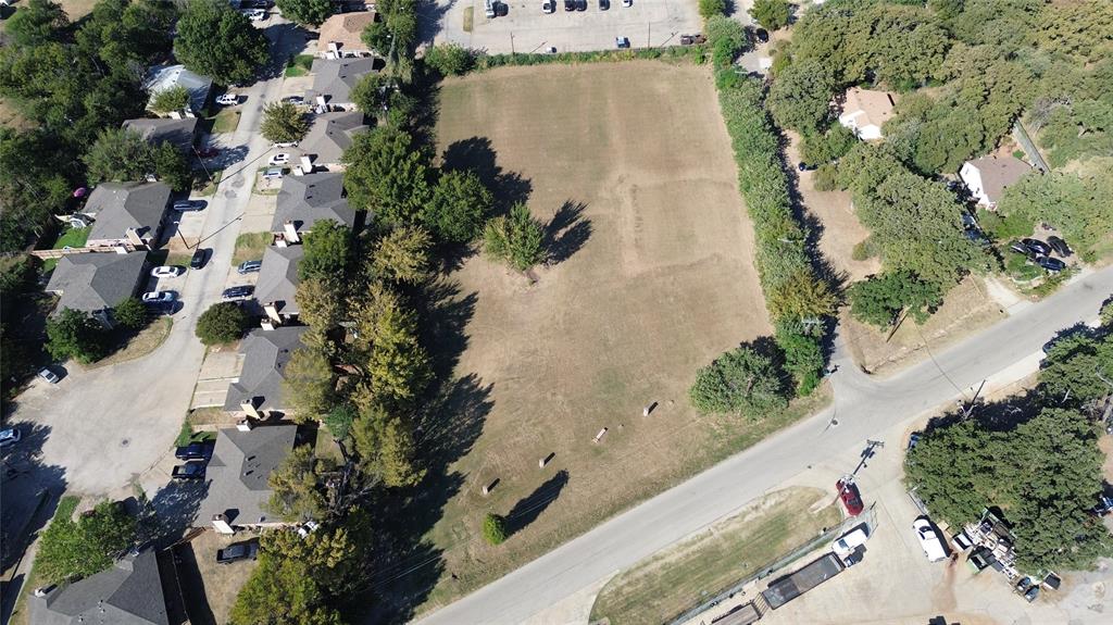801 Singleton Boulevard Irving, TX 75060 - Photo 5 of 12 an aerial view of a house with a yard and trees all around