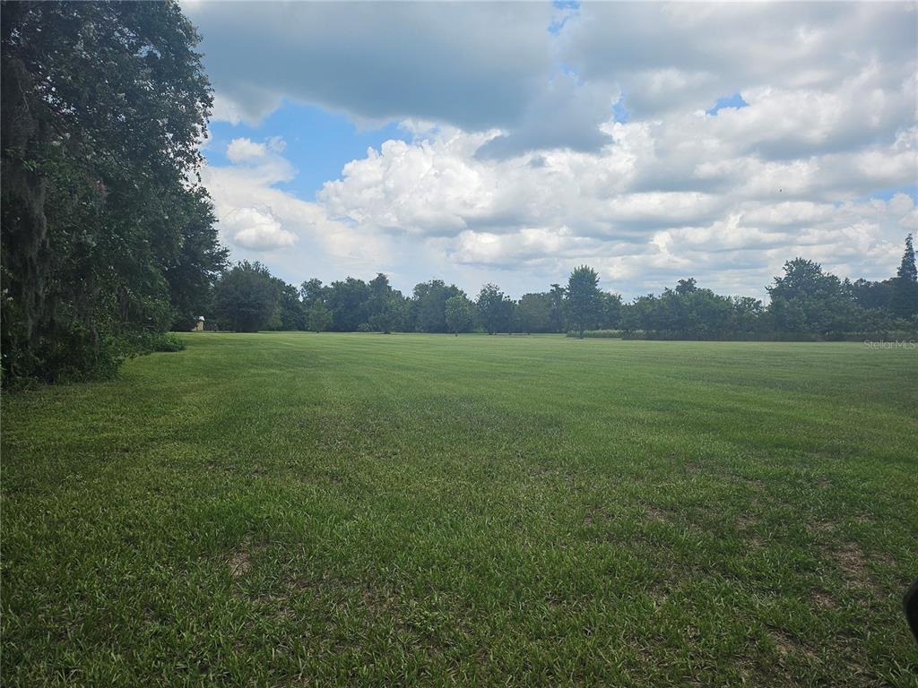 a view of a field with an outdoor space